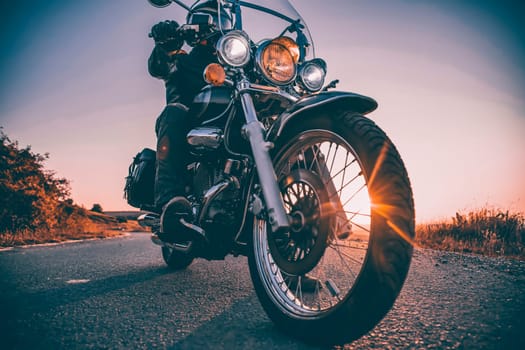 Motorcycle driver riding on countryside. Travel and sport, speed and freedom concept