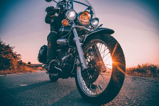 Motorcycle driver riding on countryside. Travel and sport, speed and freedom concept