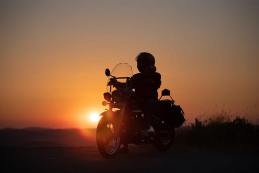 Motorcycle driver riding on countryside. Travel and sport, speed and freedom concept
