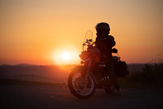Motorcycle driver riding on countryside. Travel and sport, speed and freedom concept
