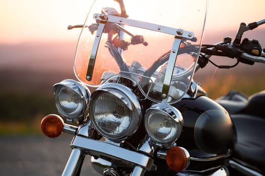 Motorcycle detail closeup front fork and headlight. Travel and sport, speed and freedom concept