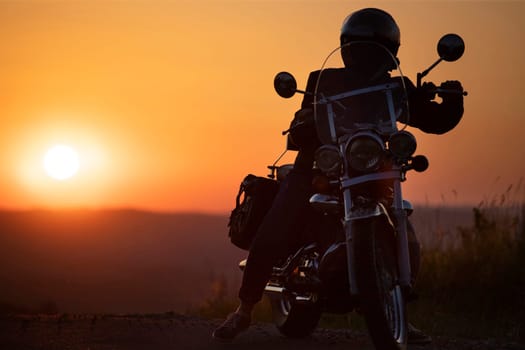 Motorcycle driver riding on countryside. Travel and sport, speed and freedom concept