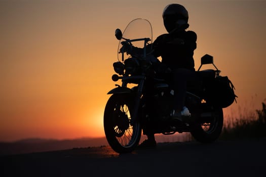 Motorcycle driver riding on countryside. Travel and sport, speed and freedom concept