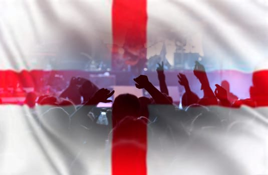 Football fans supporting England - crowd celebrating in stadium with raised hands against England flag