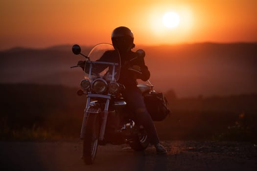Motorcycle driver riding on countryside. Travel and sport, speed and freedom concept