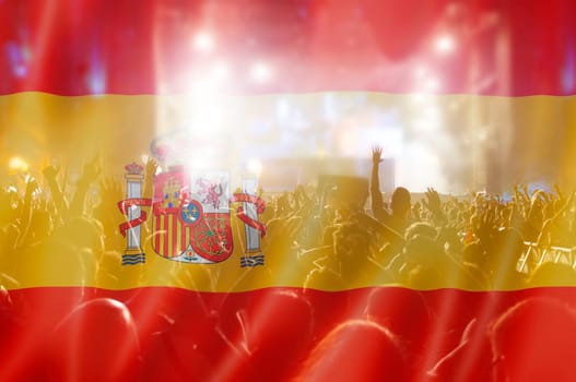 Soccer fans supporting Spain - crowd celebrating in stadium with raised hands against Spain flag