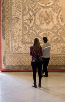 Ecija, Spain - April 21th, 2019: Visitors couple at Ecija Municipal Museum of History, Seville, Spain
