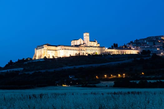 Assisi Basilica by night in Umbria region, Italy. The town is famous for the most important Italian St. Francis Basilica (Basilica di San Francesco)