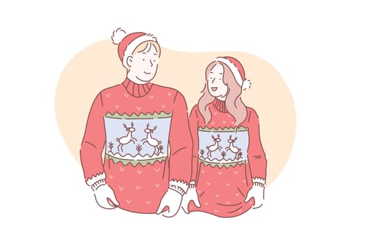 A young loving couple in christmas sweaters with deer are preparing to celebrate a Merry Christmas and Happy New year.