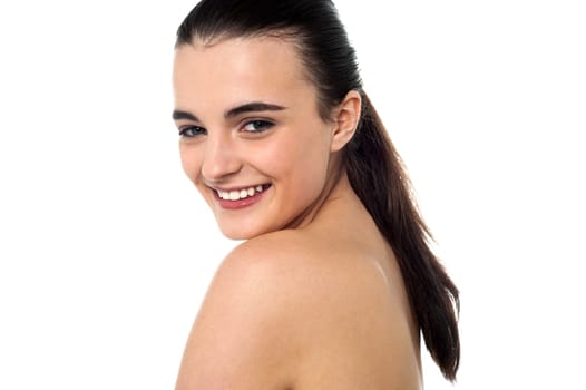 Glamorous young sensual female model posing topless.