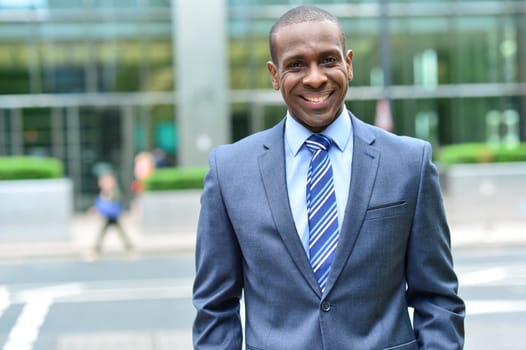 Businessman posing on modern building background