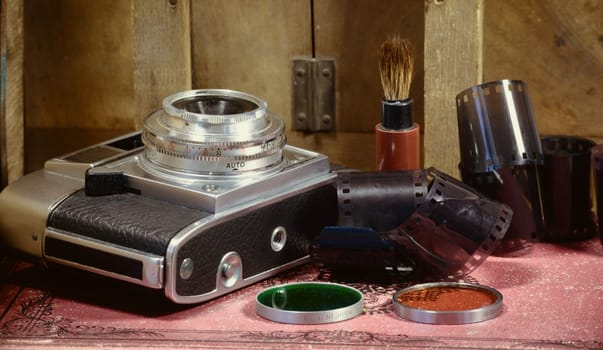 old camera with some accessories and films