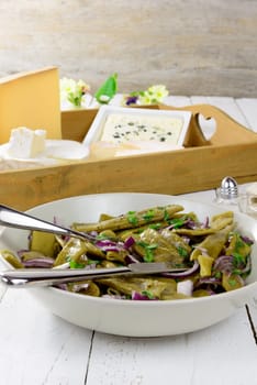 plate of fresh green beans with cheeses