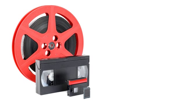 old reel of film, video tape and memory card on white
