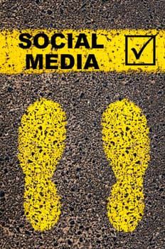 Conceptual image with yellow paint footsteps on the road in front of horizontal line over asphalt stone background. Word XXXXXXXX