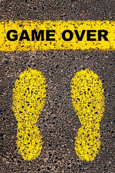 Conceptual image with yellow paint footsteps on the road in front of horizontal line over asphalt stone background. Word XXXXXXXX