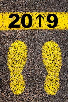 Conceptual image with yellow paint footsteps on the road in front of horizontal line over asphalt stone background. Word XXXXXXXX