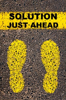 Conceptual image with yellow paint footsteps on the road in front of horizontal line over asphalt stone background. Word XXXXXXXX