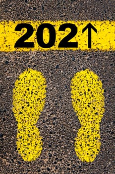 Conceptual image with yellow paint footsteps on the road in front of horizontal line over asphalt stone background. Word XXXXXXXX