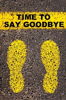 Conceptual image with yellow paint footsteps on the road in front of horizontal line over asphalt stone background. Word XXXXXXXX