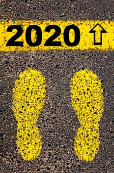 Conceptual image with yellow paint footsteps on the road in front of horizontal line over asphalt stone background. Word XXXXXXXX