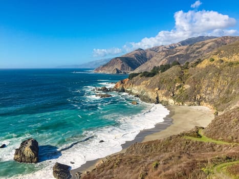 California big sur coast, ocean, mountains and blue sky with clouds in background