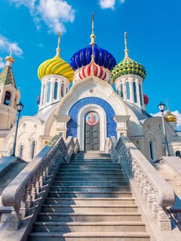 Domes of russian church with blue sky and clouds in background