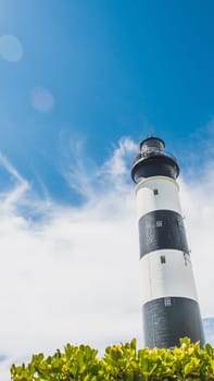 The Chassiron lighthouse with black and white stripes on blue sky, on the island of Oléron in France