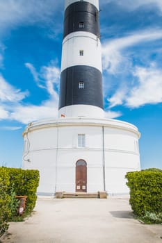 The Chassiron lighthouse with black and white stripes on blue sky, on the island of Oléron in France