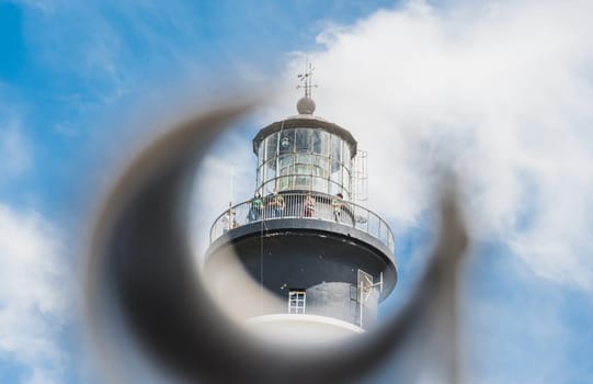 The Chassiron lighthouse with black and white stripes on blue sky, on the island of Oléron in France