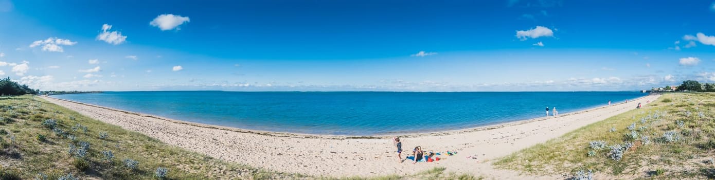Panorama of the Plage de la Phibie on the islande of Oléron, under a beautiful blue sky in France