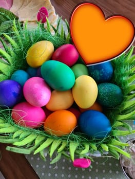 Happy Easter, Easter basket with colorful Easter eggs and heart with copy space