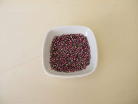 Dried pink heather flowers on a wooden board