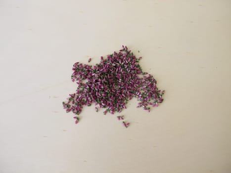 Dried pink heather flowers on a wooden board