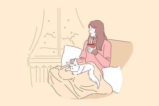 Cozy, relax, dream concept. Young woman or girl enjoys the comfort of sitting on a chair with a blanket and caressing her pet cat. Thoughtful lady in looks out the window and drinks tea or coffee.