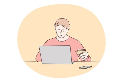 Online shopping, technology, business, payment concept. Young happy man freelancer sitting with laptop in office or home and holding plastic deposit card. Online investment and financial ecommerce.