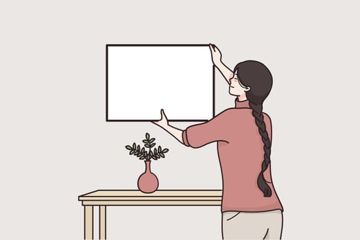 Frame, mockup, interior decorative elements concept. Young smiling woman hanging photo frame on wall at home mockup feeling glad decorating interior vector illustration