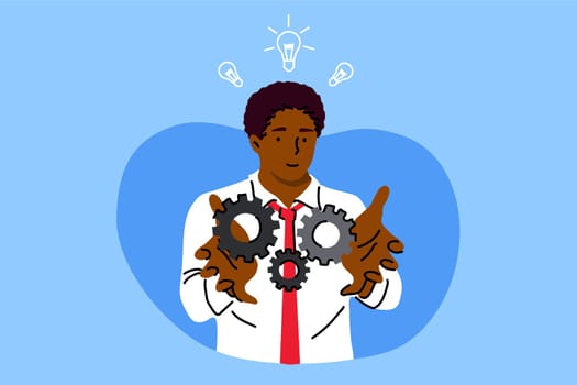 Business, work, success, idea, achievement, analysis concept. Young happy african american businessman clerk manager holding technology gear in hands. Productive work moving towards goals illustration