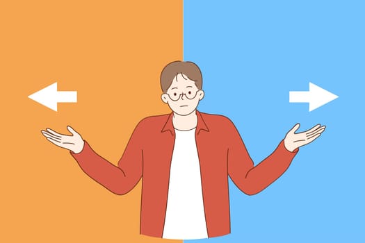 Doubt, Making decision, hard choice concept. Frustrated young man spreading outstretched arms trying to choose right or left direction and right way path to go feeling uncertain frustrated