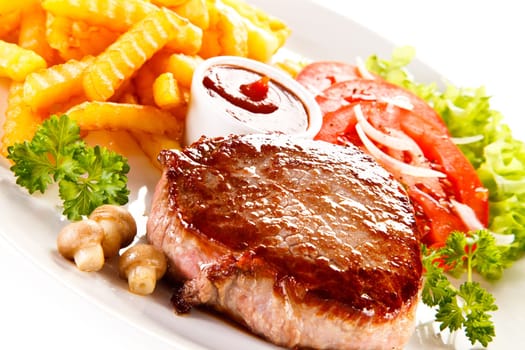 Grilled steak, French fries and vegetables