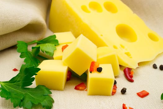 a piece of cheese with spices on canvas