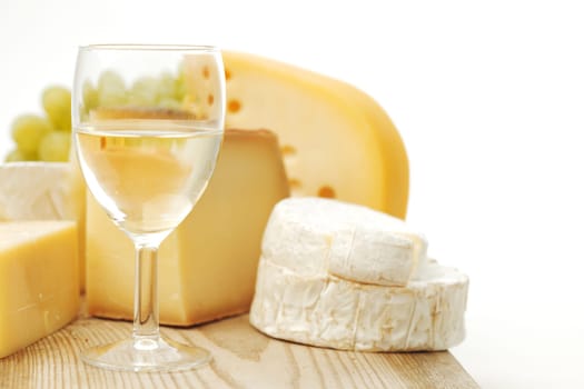 cheese and wine on a wooden table