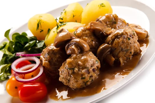 Broiled meatballs, boiled potatoes and vegetables