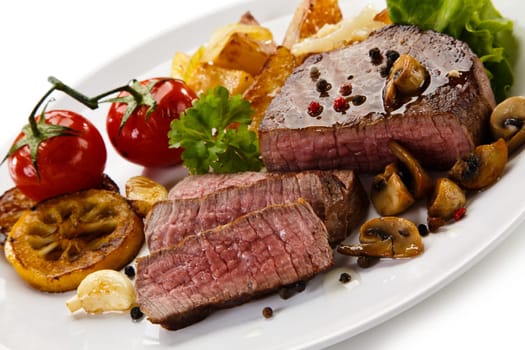 Steaks, baked potatoes and vegetable salad