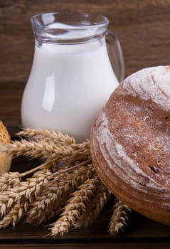 Assortment of baked bread on wooden table background