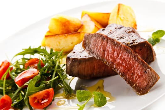 Grilled steaks, baked potatoes and vegetables