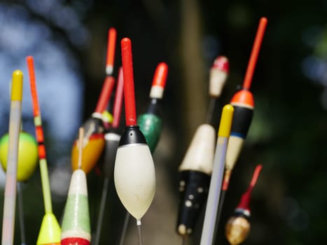 heap multicolored of fishing bobbers close up