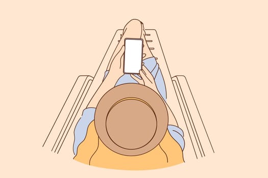 Copy space, online communication concept. Top view of person sitting holding mobile phone with blank white screen in hands vector illustration