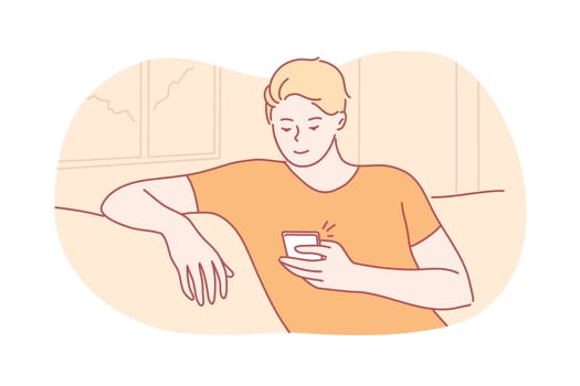 Quarantine, recreation, communication, coronavirus concept. Young man or boy sitting on couch at home browsing internet with smartphone. Connection with people on lockdown during covid19 infection.