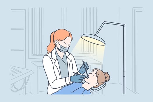 Teeth examination and dentistry checkup concept. Dentist woman holding instruments and examining girl teeth looking inside mouth. Patient lying down in dental chair.